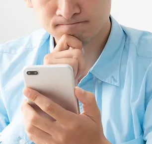 frustrated person looks at mobile